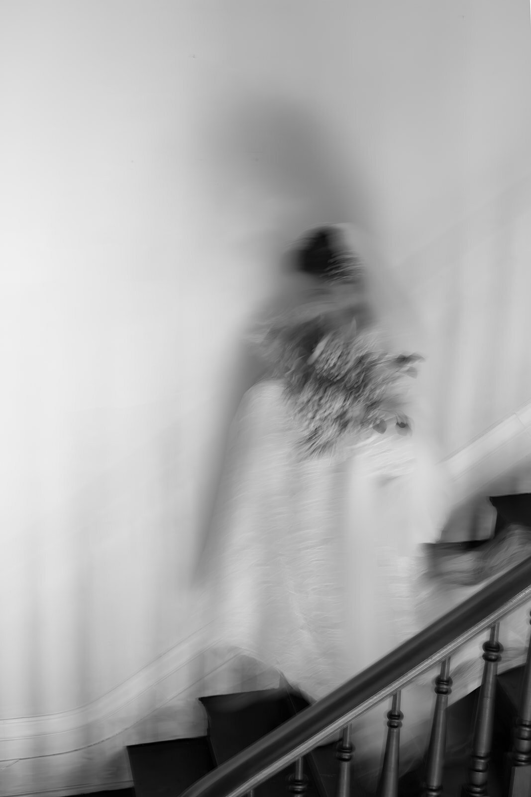 Blurry black and white bridal portraits going downstairs