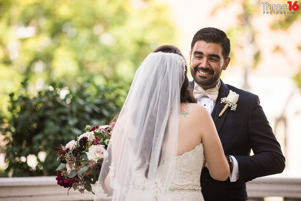 It's all smiles for this Groom as he looks at his Bride