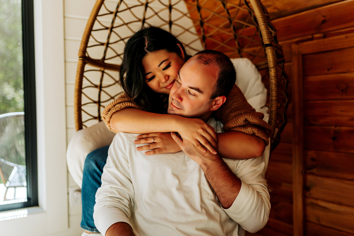 couple cuddling in egg chair