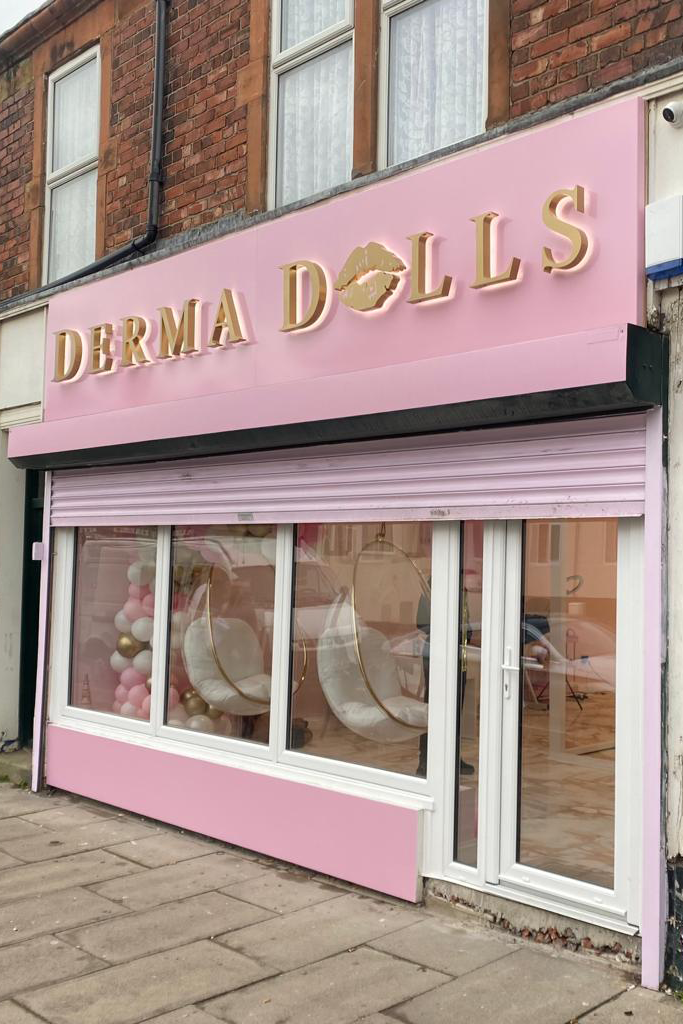 Derma Dolls Gold and Pink Signage