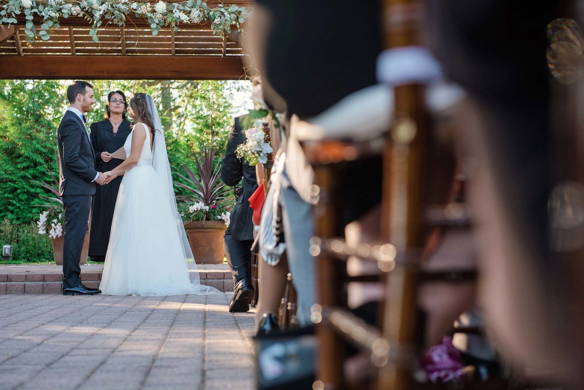 Bride and groom at the altar from point of view of guests at Stonebridge Country Club