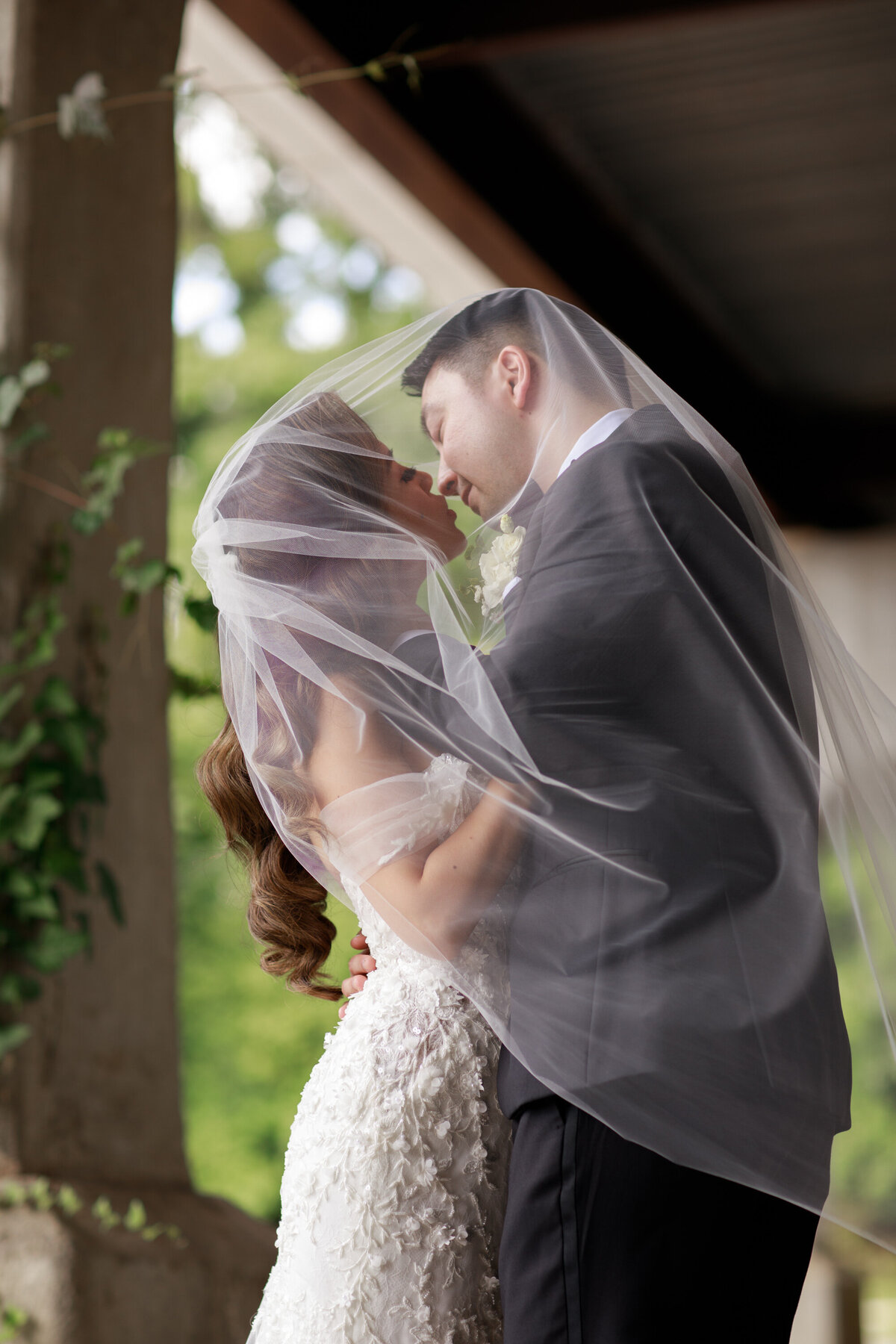 bride and groom under the veil shot
