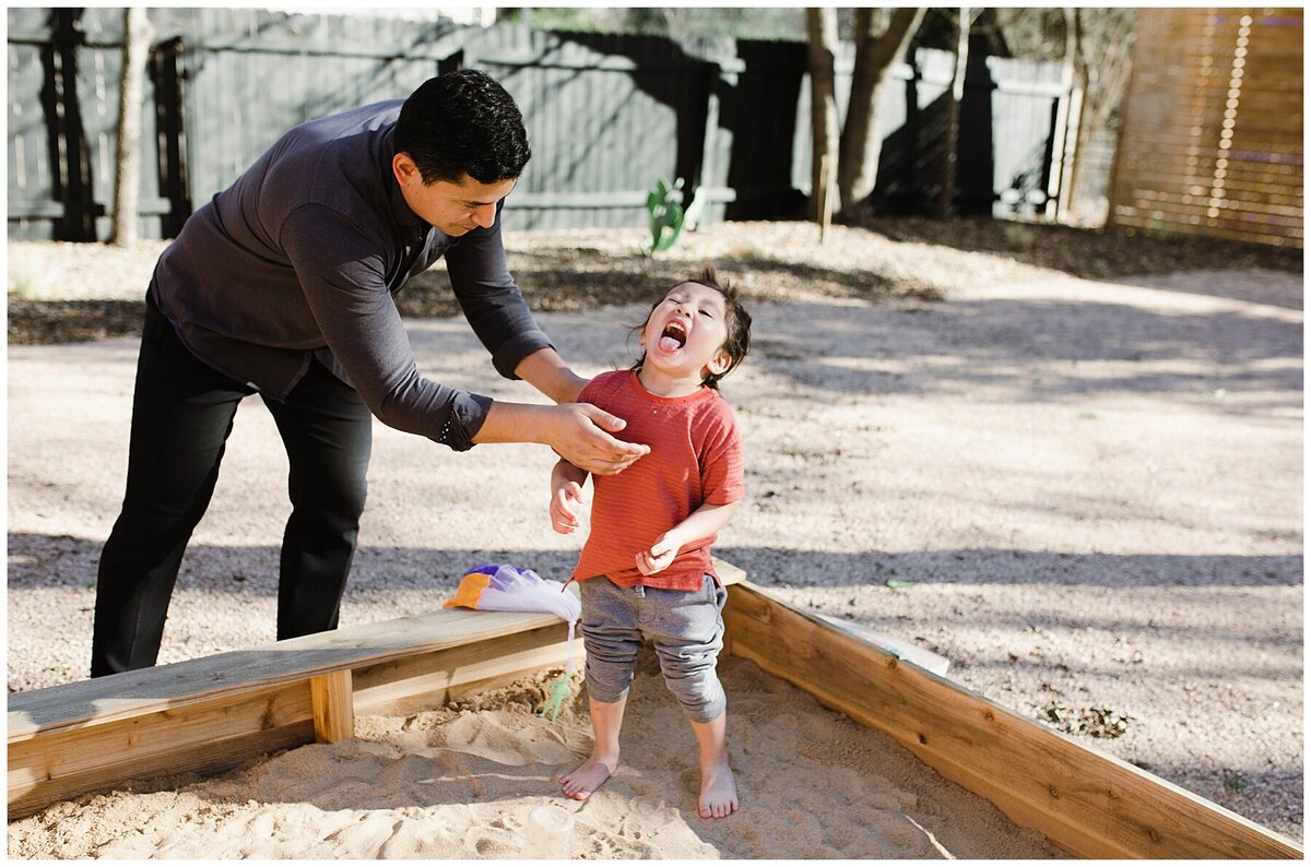 Father helping child in sandpit at  garden family session in Austin by Amber Vickery Photography
