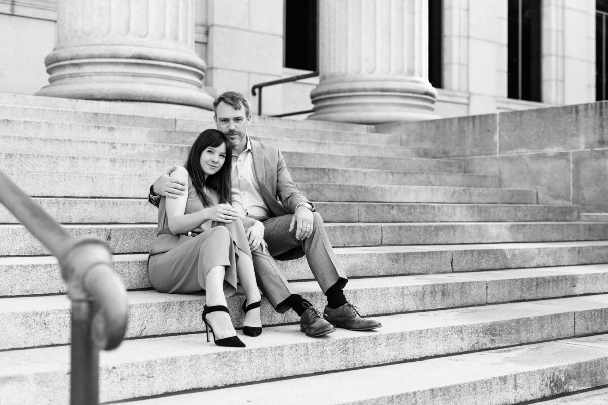 Black and white image of couple sitting on steps