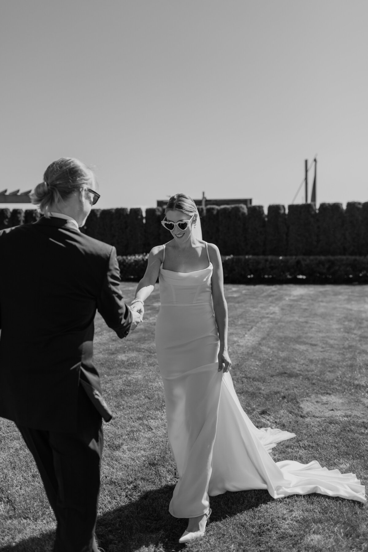 A fun candid moment of a bride and groom walking captured by Fort Worth wedding photographer, Megan Christine Studio