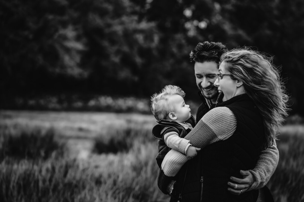black and white image of parents with their son during family photoshoot at bradgate park