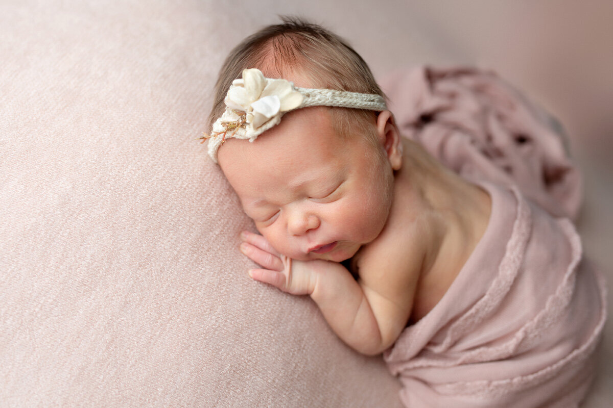 Newborn session of baby girl wearing a headband