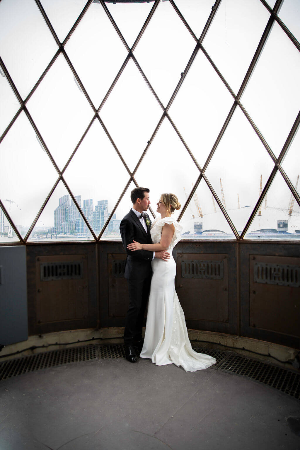 Bride and groom in Trinity Buoy Wharf lighhouse