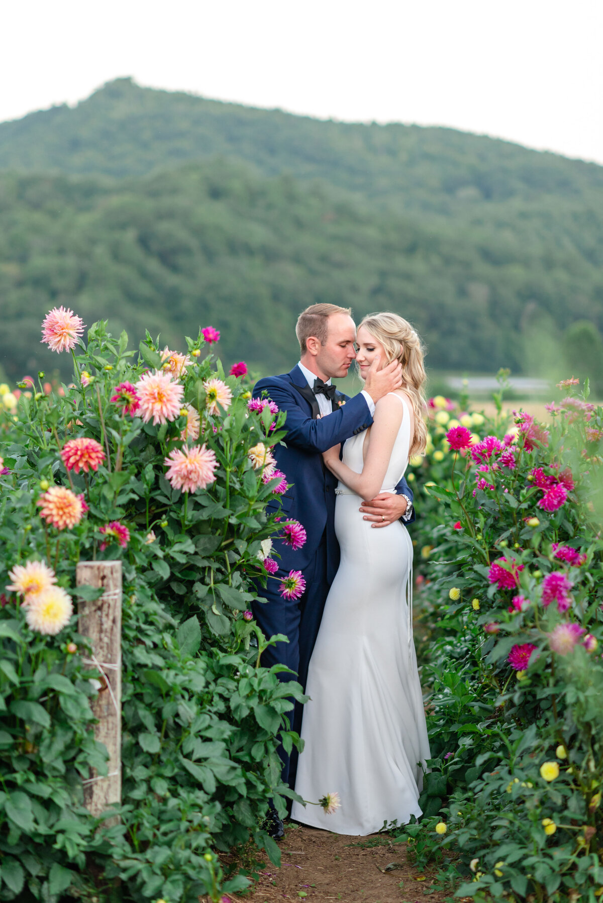 Bride and groom embrace in flowers
