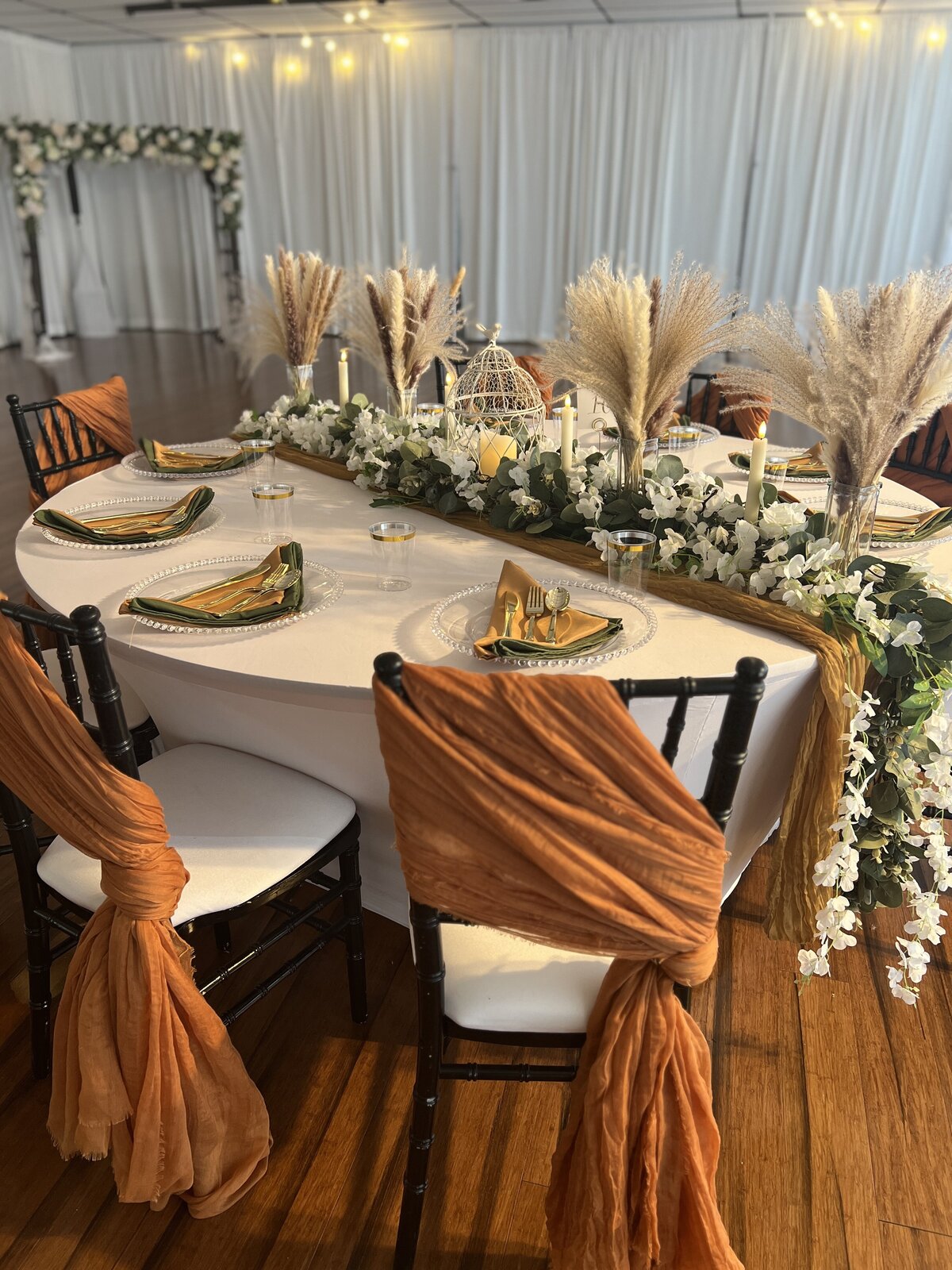 Guest table showcasing our inclusive decor package with rustic chic boho centerpieces and a simple design - Perfect for your Clearwater celebration
