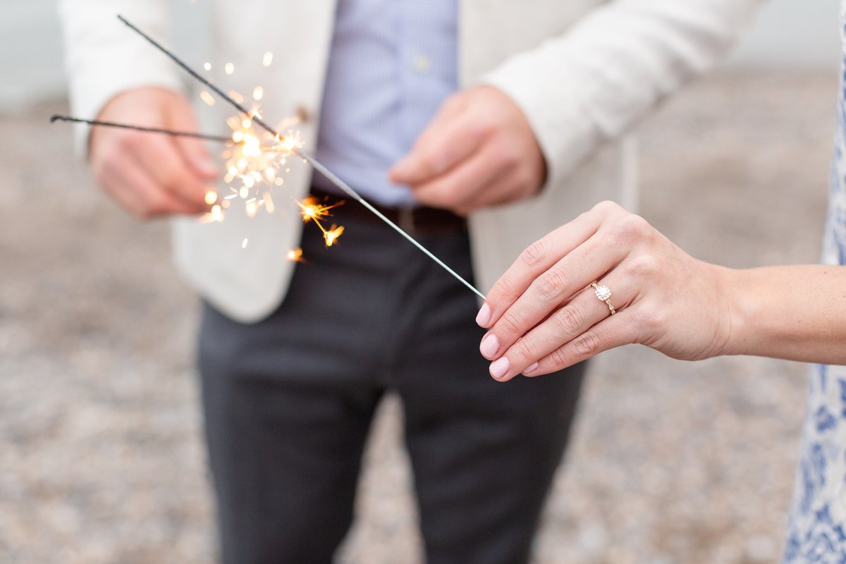 Couple-lights-sparklers-to-celebrate-their-engagement-on-the-beach-at-point-pelee-national-park