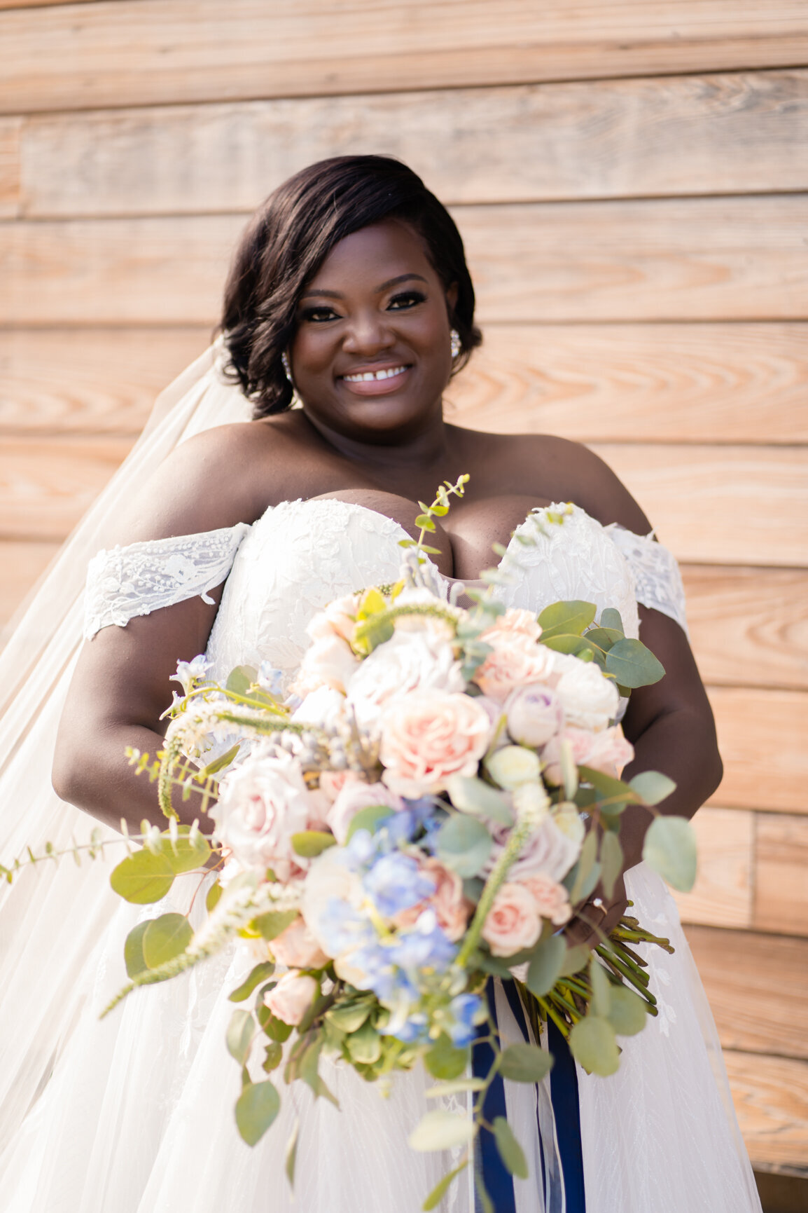 African American bride shows off her bouquet