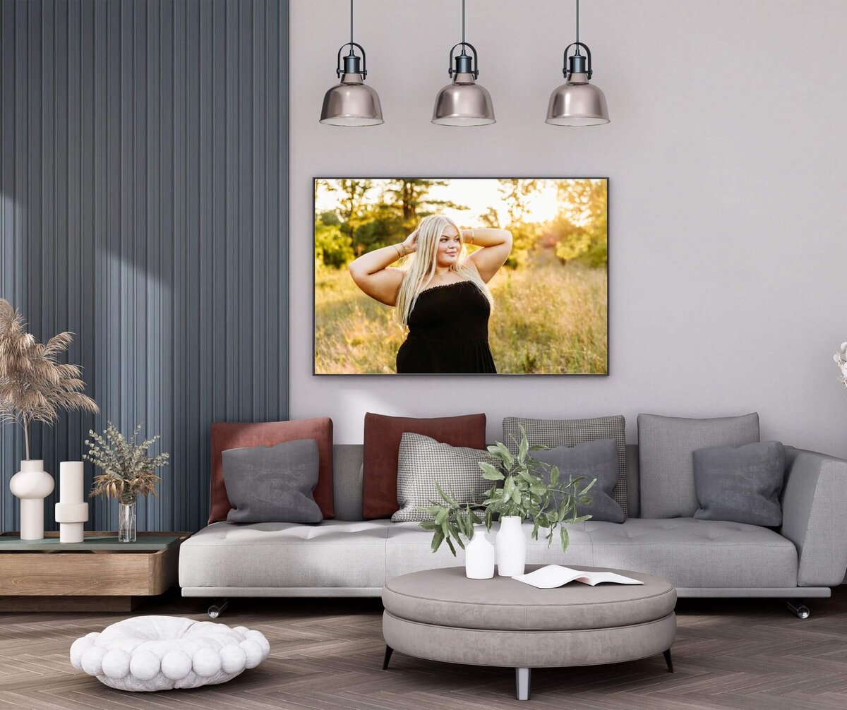 stylish grey and blue living room with a beautiful senior photo being displayed on the wall