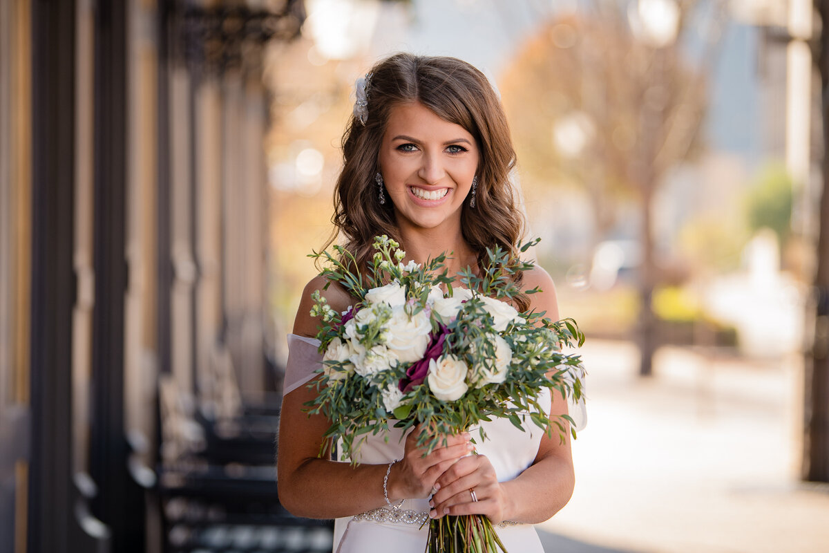 bride smiling and holding bouquet