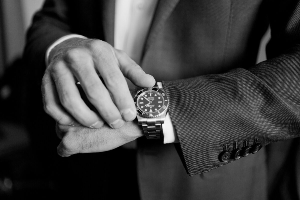 Groom admires his Rolex watch before his wedding