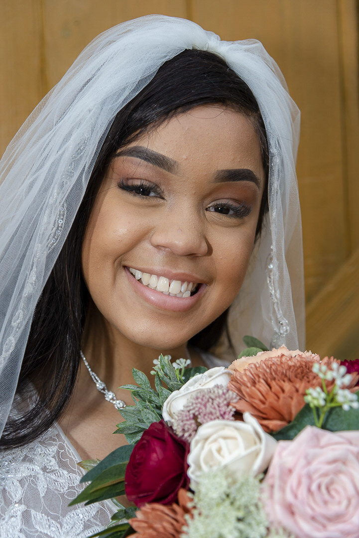 A bride poses with her bouquet for a bridal portrait.