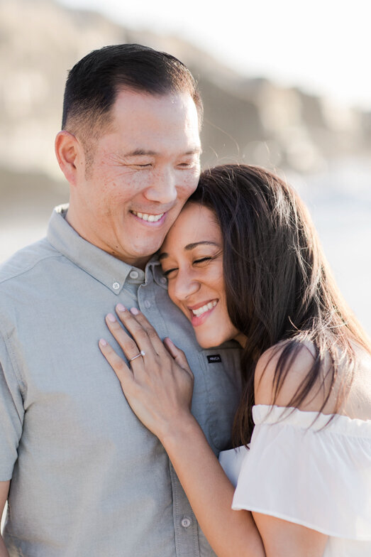 couple hugging and laughing at La Jolla Beach