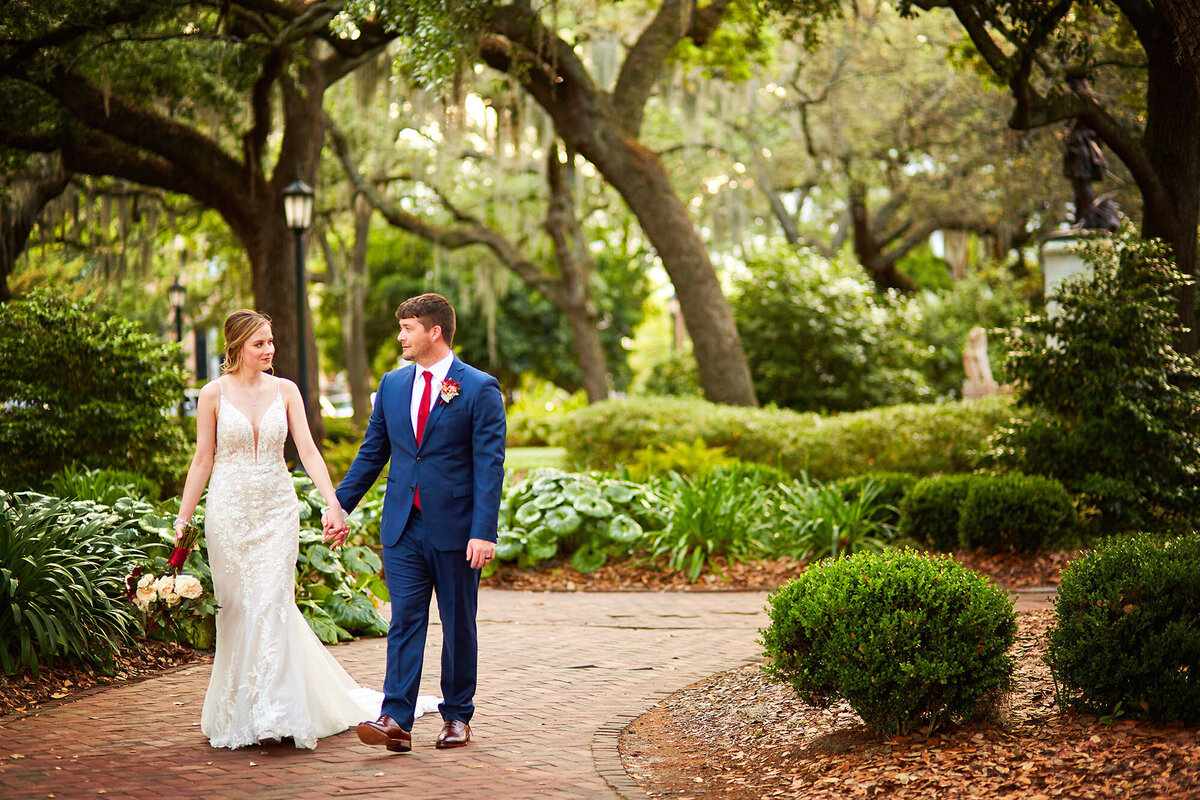 Bride and groom walk in Chippewa Square, Savannah wedding photographer