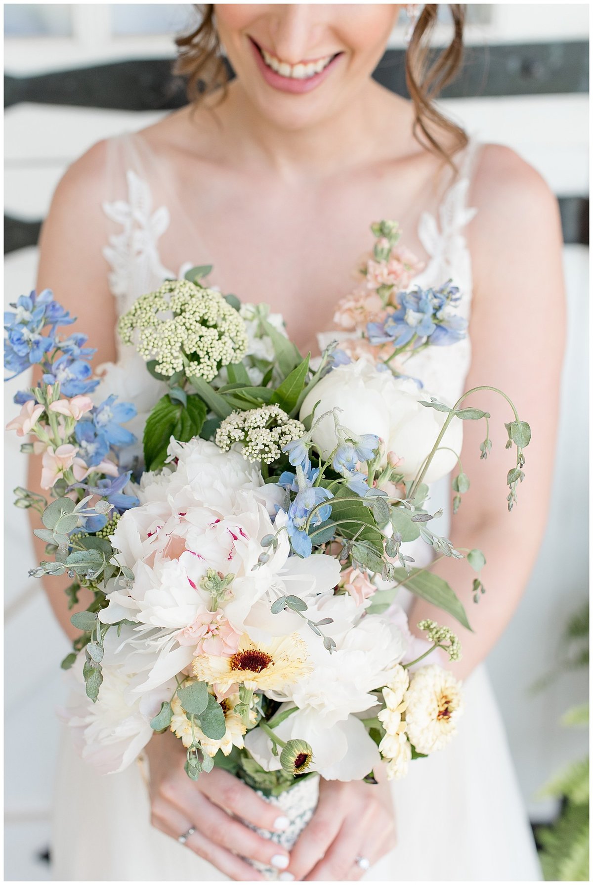 Colorful close-up photo of bridal bouquet filled with dahlias, eucalyptus, and other colorful flowers.