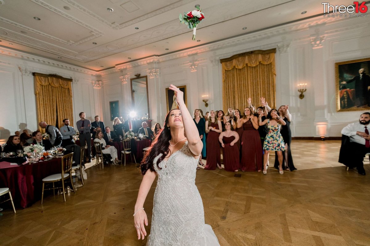 Bride tosses the wedding bouquet