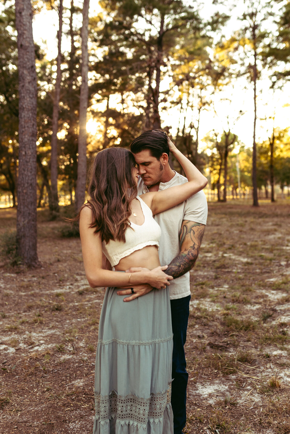 couple embraces intimately in couples outdoor session in niceville fl.