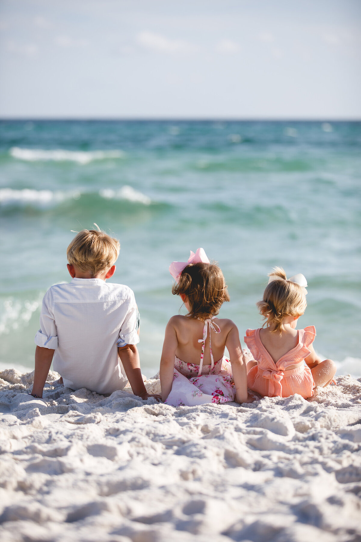 siblings sitting on beach at Rosemary