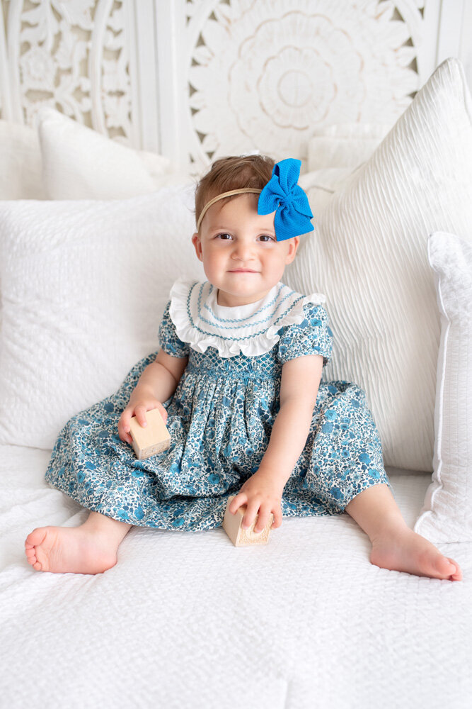 Family session of little girl with a blue bow and dress