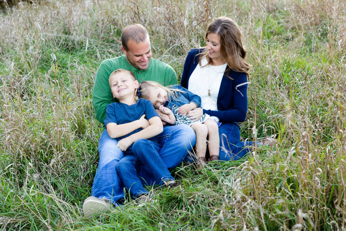 Lifestyle candid family moment in grassy pasture