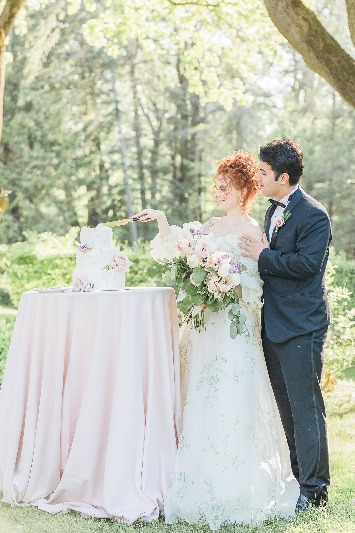 Bride and groom cut a cake at their french-inspired countryside wedding. Captured by best Massachusetts wedding photographer Lia Rose Weddings