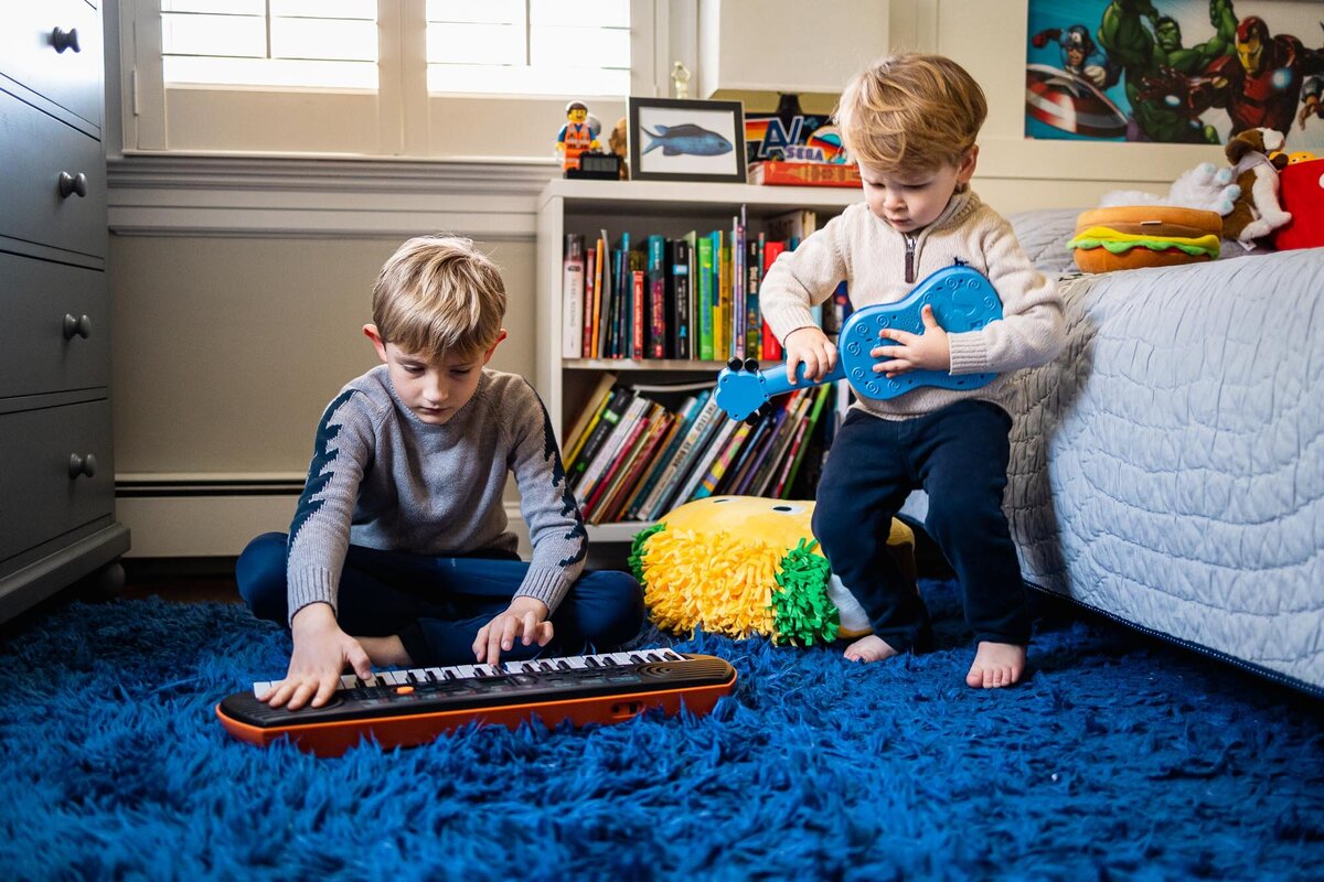 brothers playing instruments during long island in home family photo session