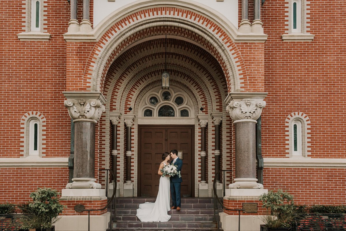A portrait of a couple in front of St John's Cathedral in downtown Lafayette, LA