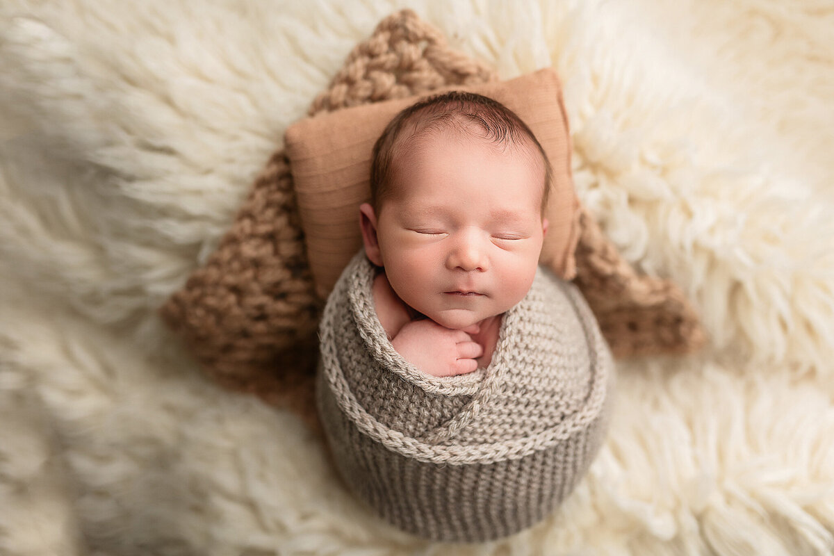 Wrapped baby boy sleeping during his newborn session.