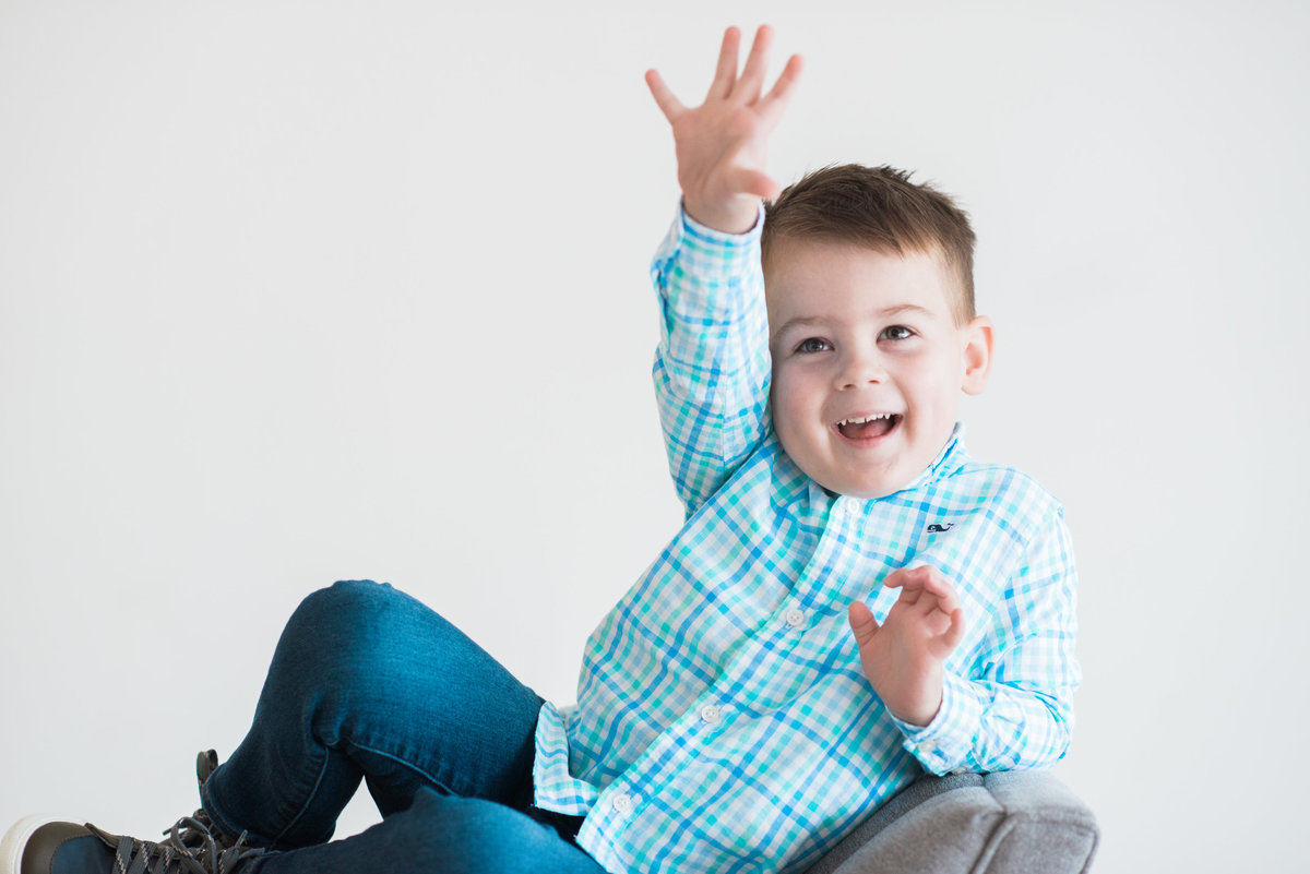 preschool boy in blue plaid shirt smiling