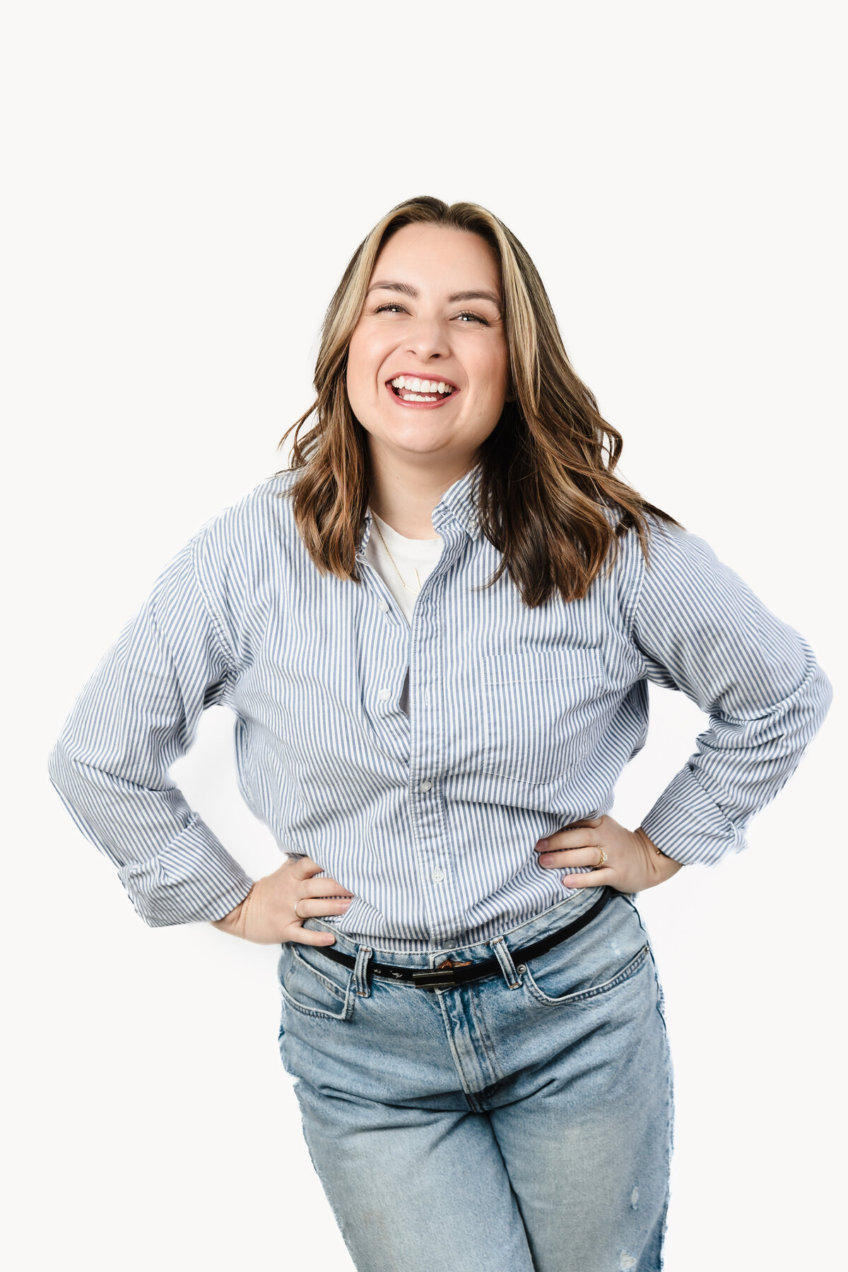 brand photo of a Marketing Strategist posing with both hands in the waist
