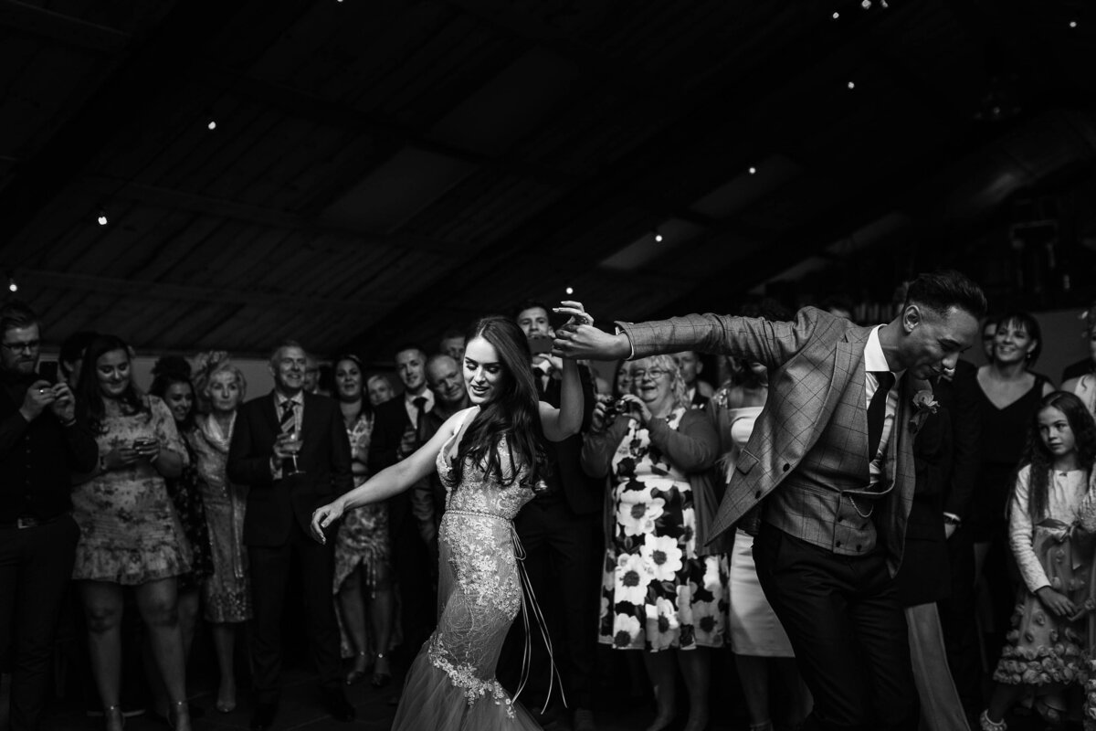 A black and white image of a couple enjoying their first dance