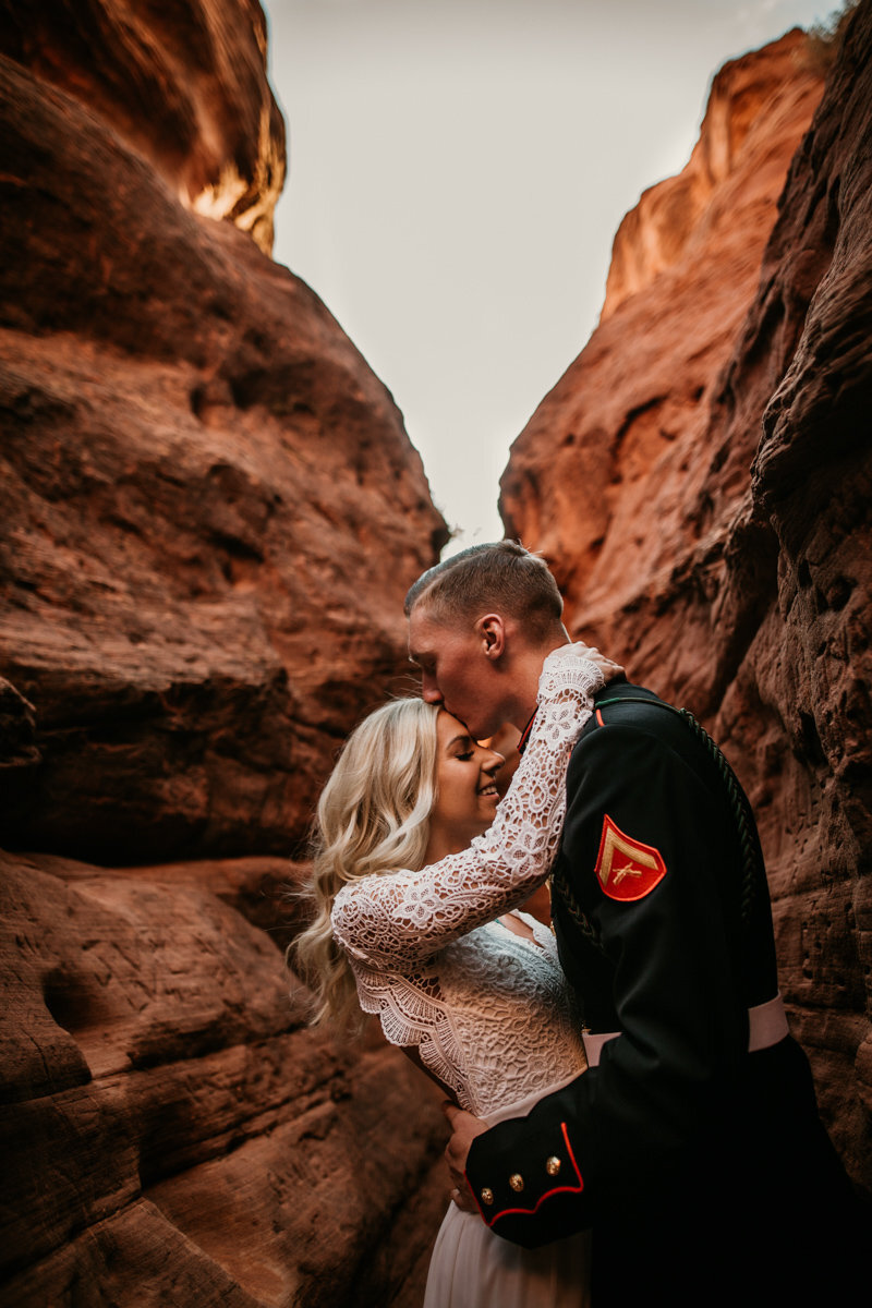husband kissing wife in New Mexico canyon