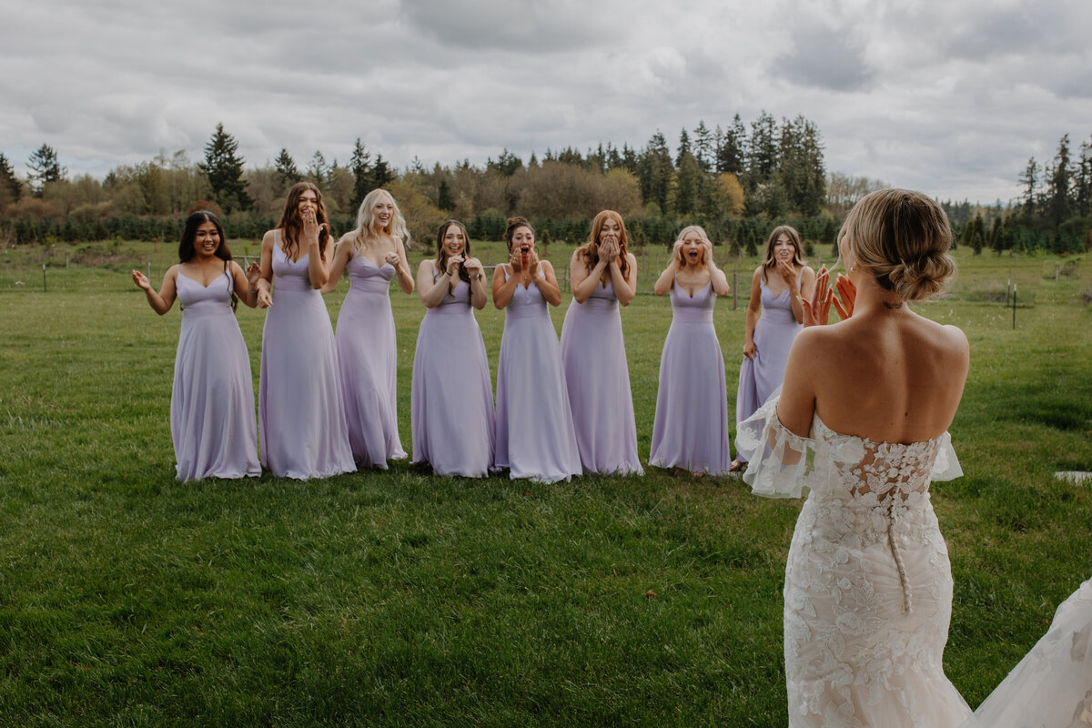 Surprised bridesmaids looking at bride