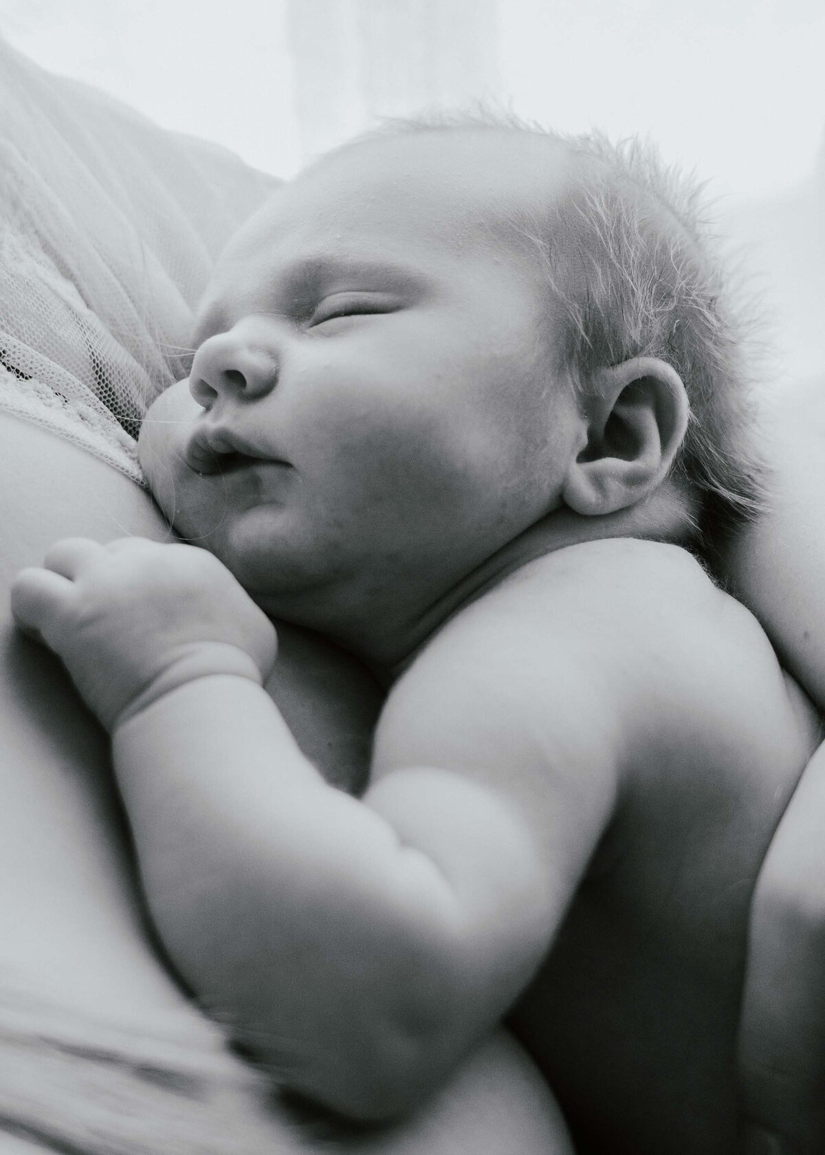 Maddie Rae Photography black and white close up of baby sleeping on moms chest