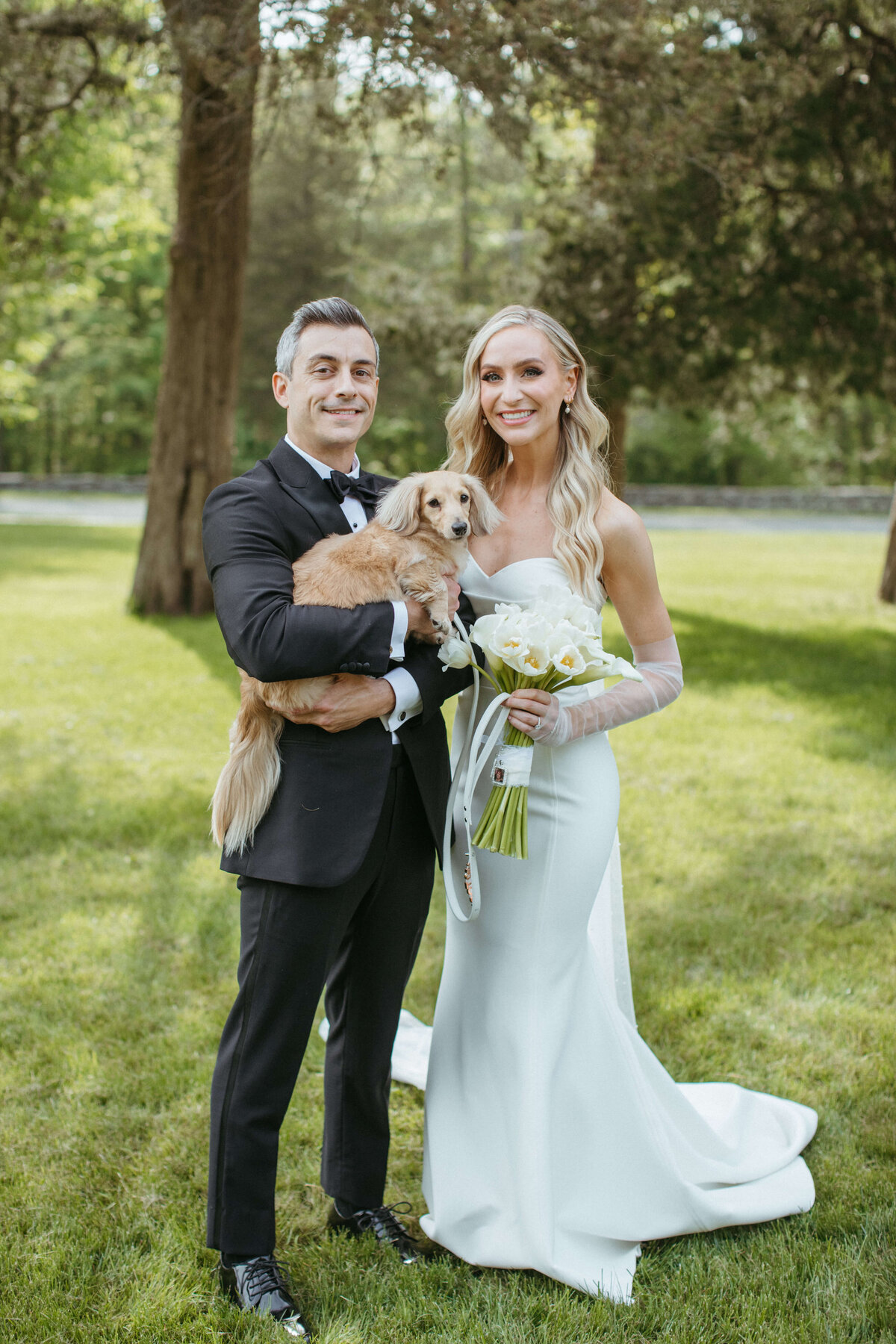 bride and groom posing with their dog