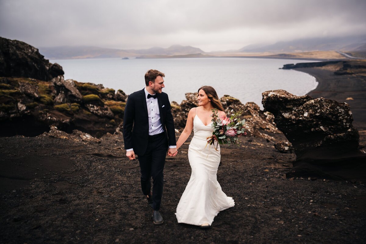 Hand in hand, this couple strolls along the captivating coast of Iceland, creating a beautiful moment in the embrace of the sea breeze and scenic beauty.