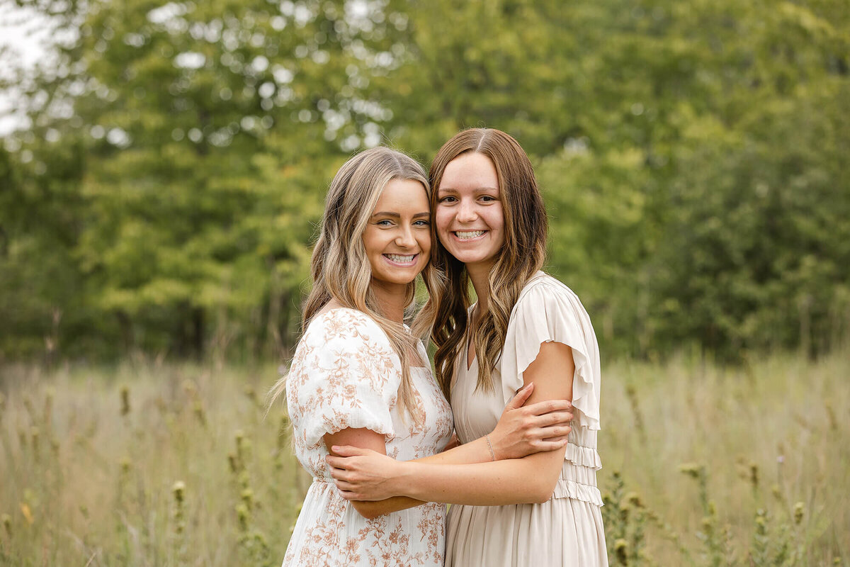 Sisters pose during their family session by Jennifer Brandes Photography.