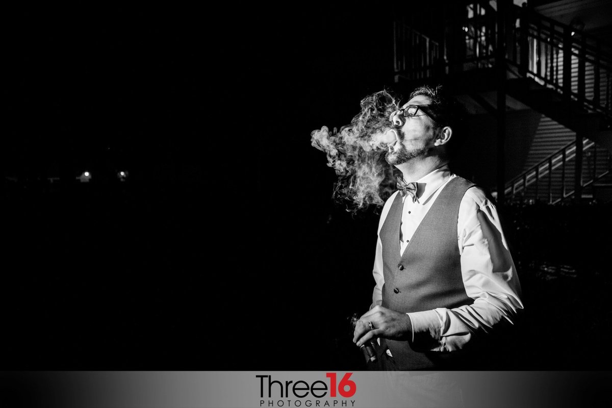 Black & White photo of Groom smoking a cigar