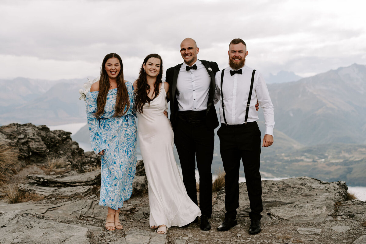 The Lovers Elopement Co - wedding party on top of mountain with lake below, heli wedding