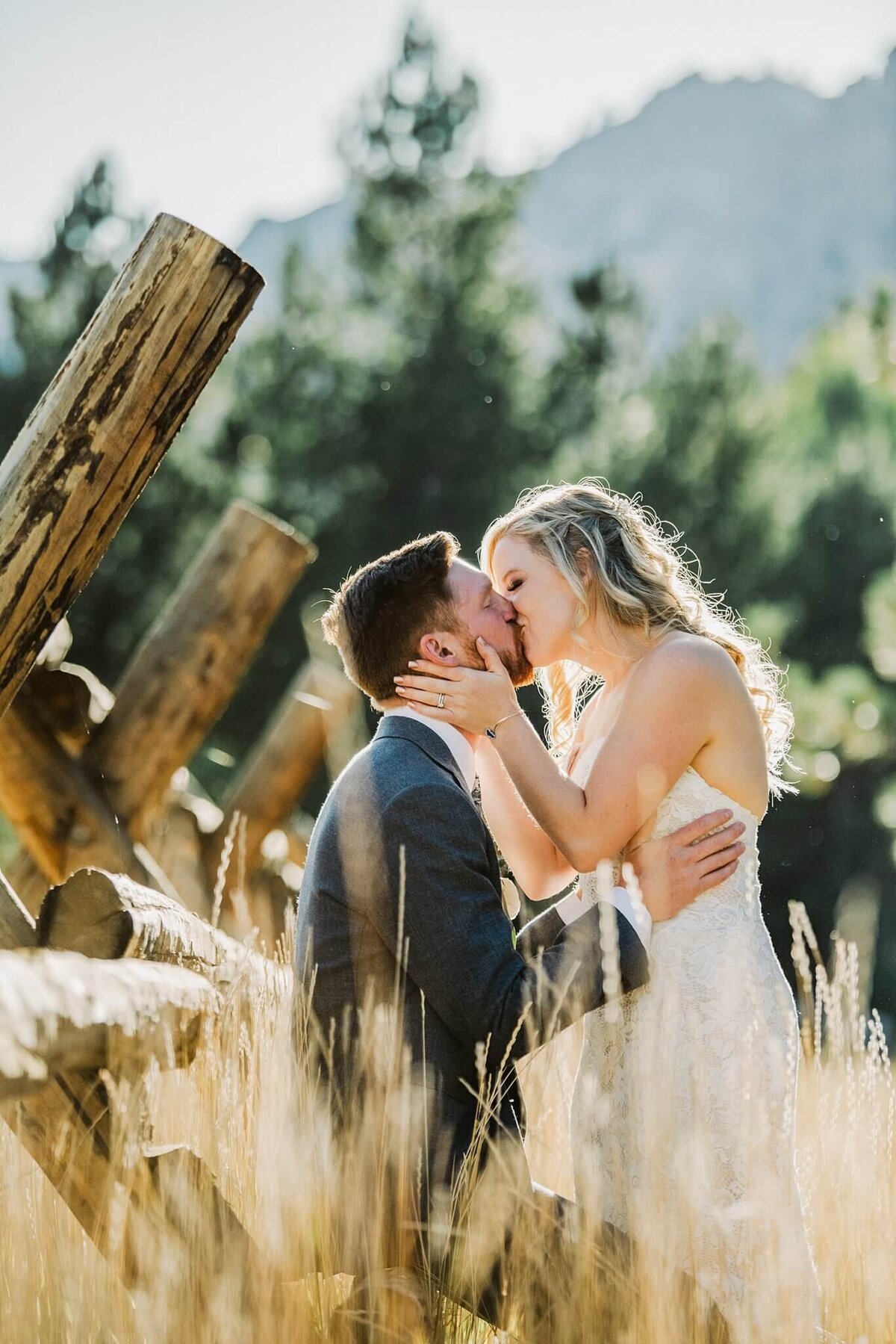 Couple kissing on fence and high weeds during a fall wedding in Palisades tahoe