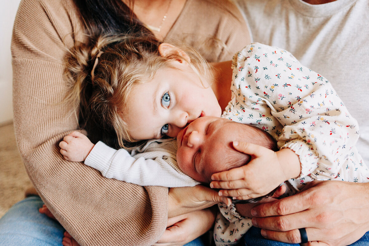 family welcoming in their newborn baby