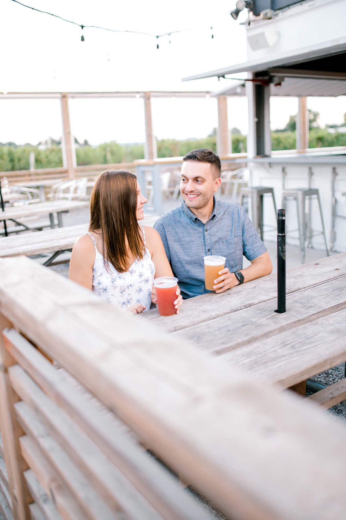 Niagara Wedding Photography captures engaged couple sitting and having a beer together