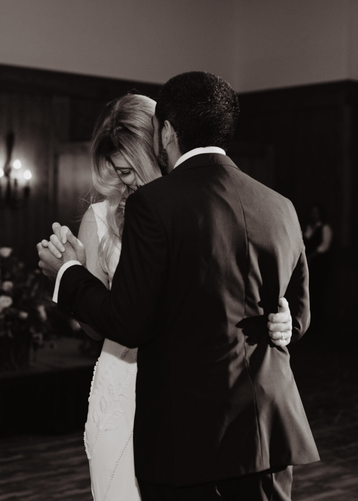 Photographers Jackson Hole capture bride dancing with groom grabbing jacket