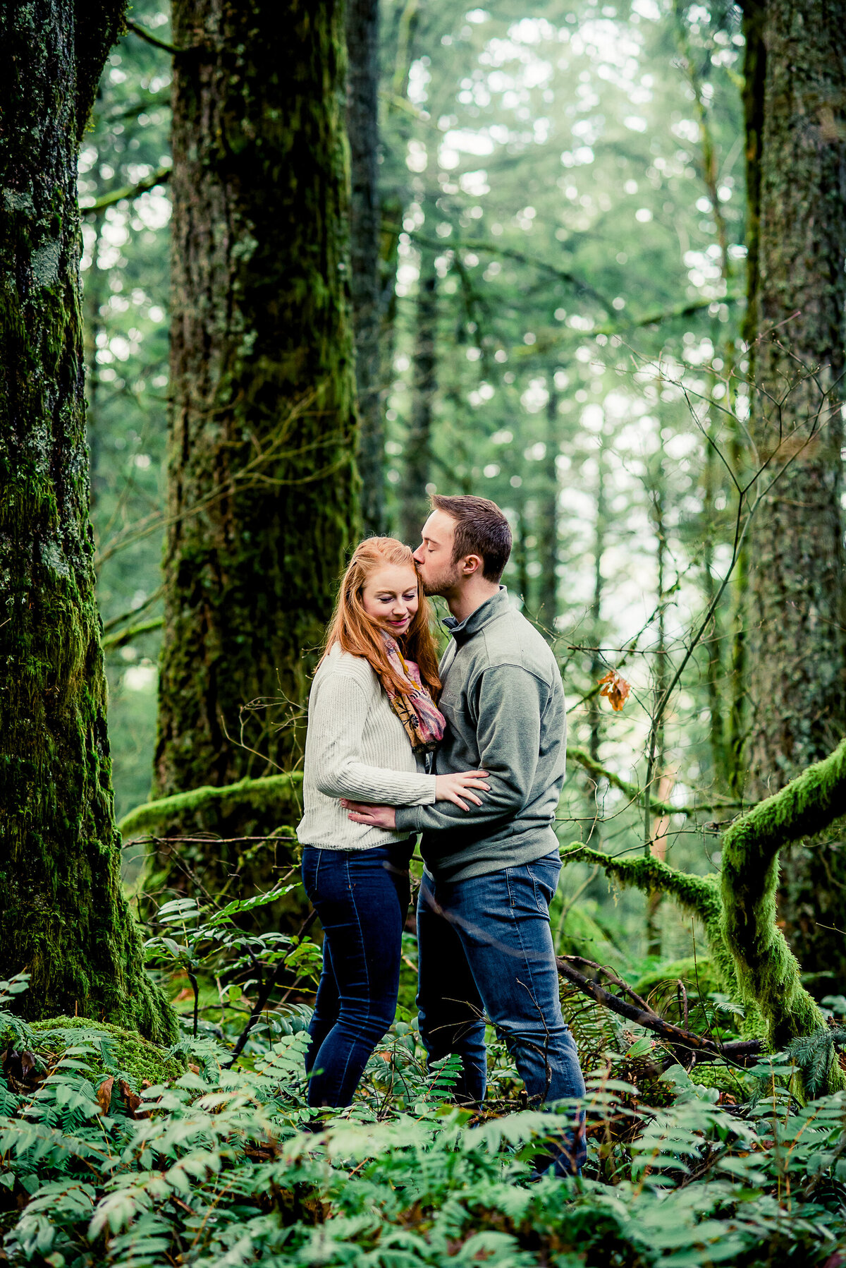 engaged couple in woods