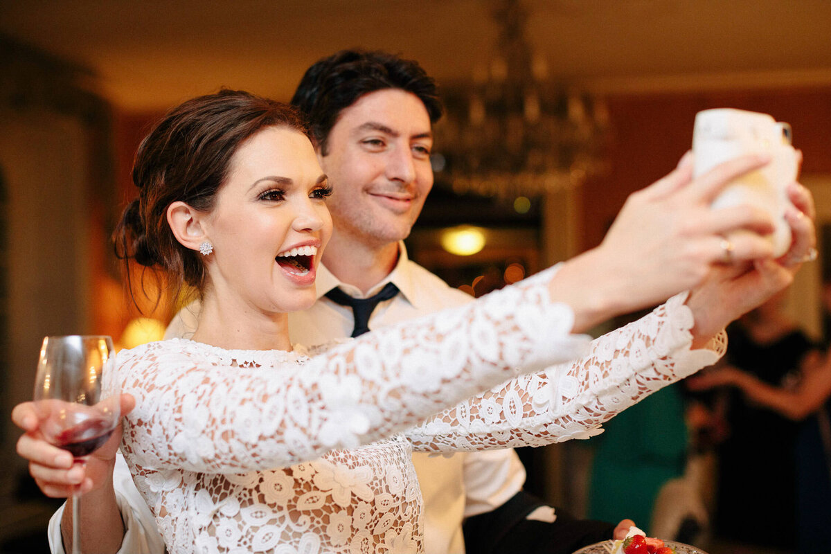 woman and man taking selfie at Italy wedding reception