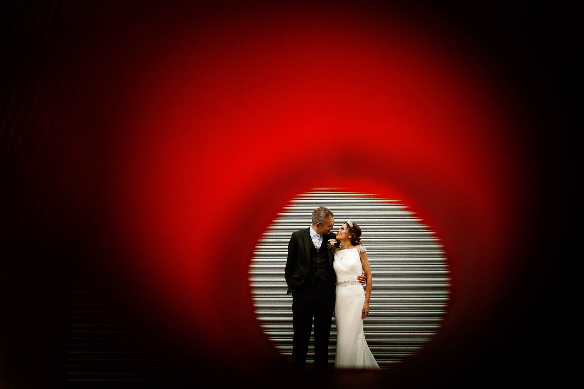 Bride and Groom stood in front of a roller shutter door at their Halifax wedding